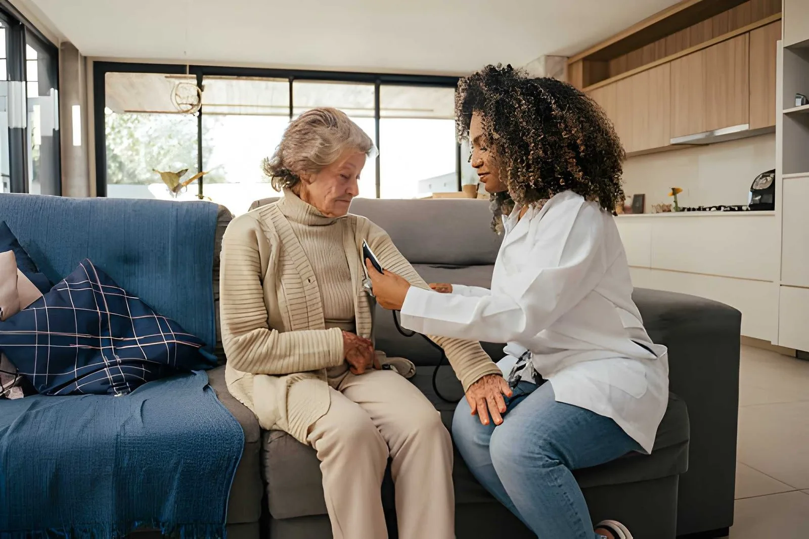 Care professional having a thoughtful conversation with an older adult
