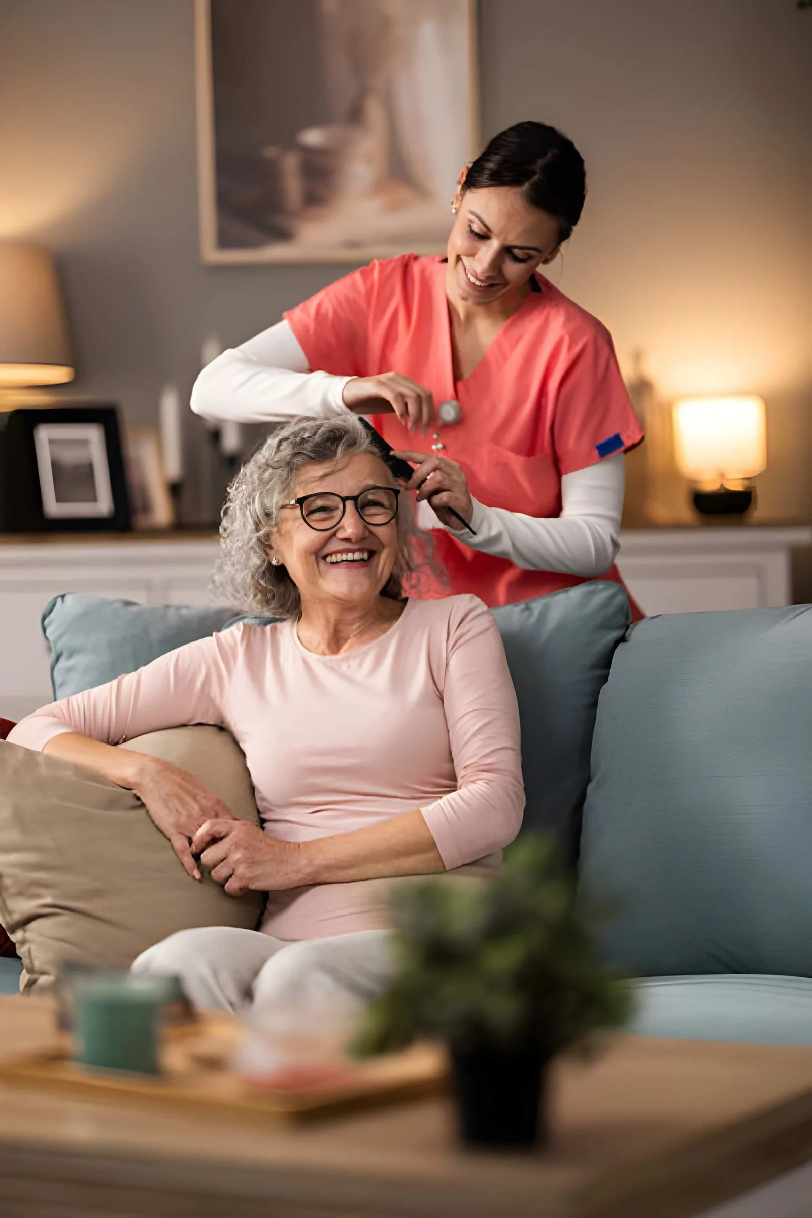 Caregiver gently helping an older adult with personal grooming