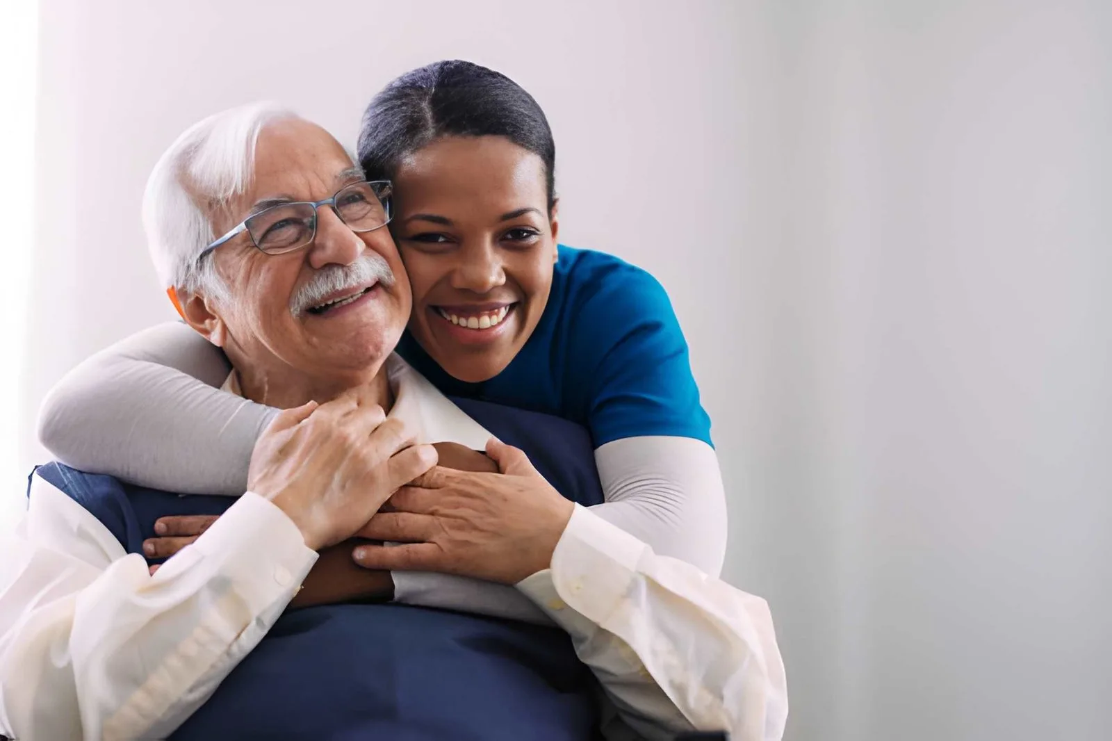 Caregiver and older adult sharing a warm embrace